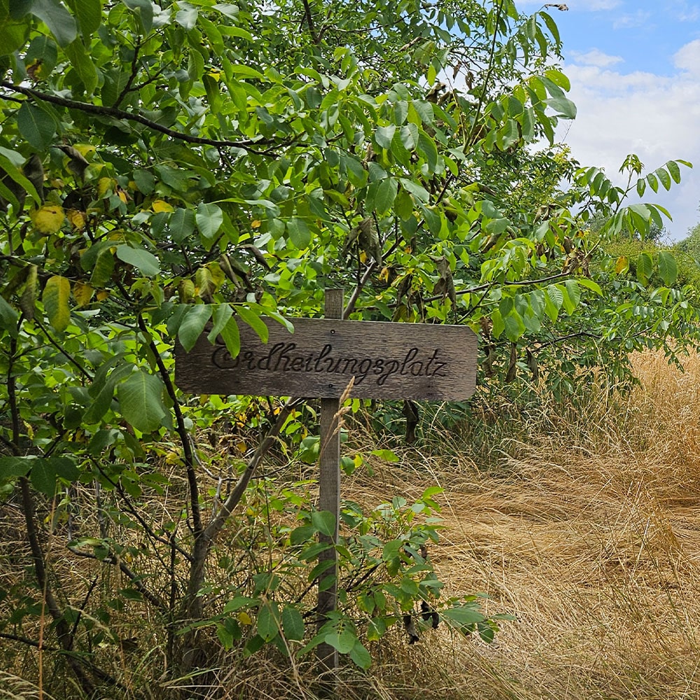 Das Schild am Erdheilungsplatz Wallendorf Eisenbahn im Juli 2025
